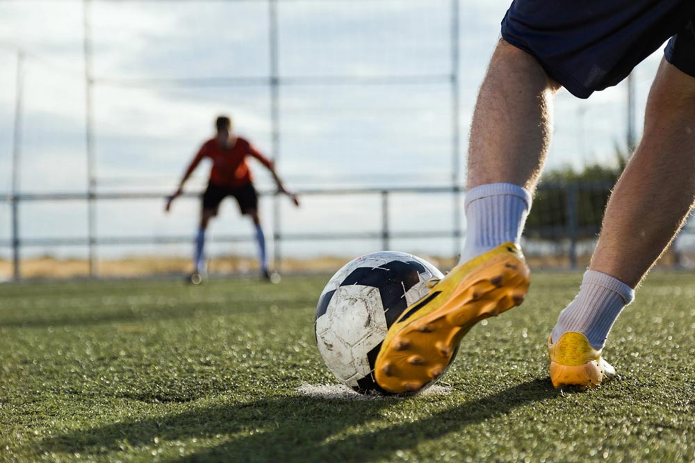 sahada futbol oynayan iki oyuncu