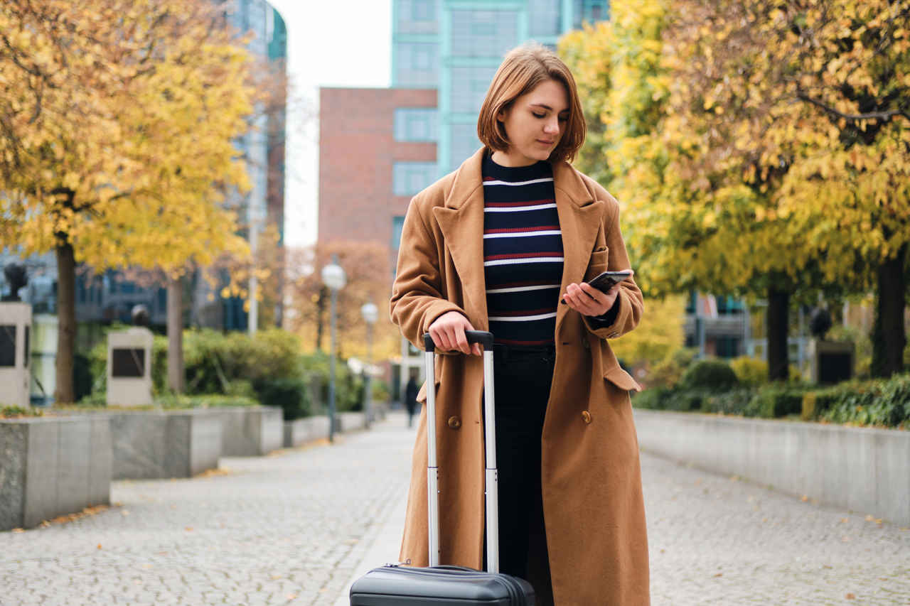 seyahat için HES kodu alan, elinde bavul taşıyan genç kadın