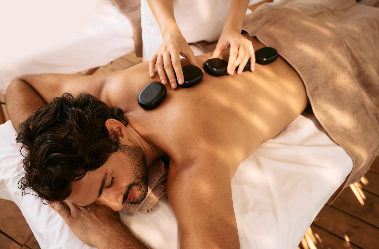 a man having a hot stone massage