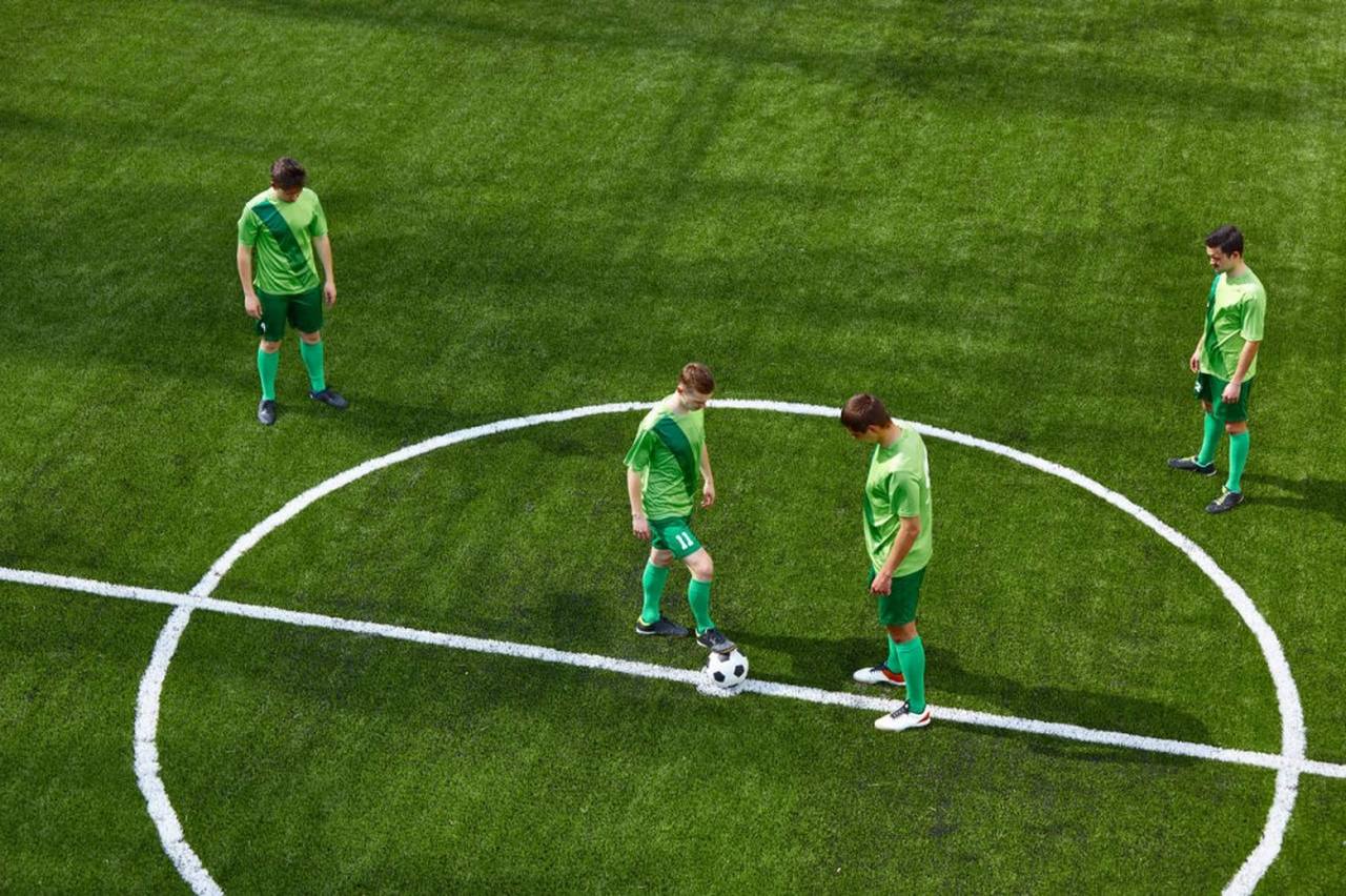 football players in the centre of a football field