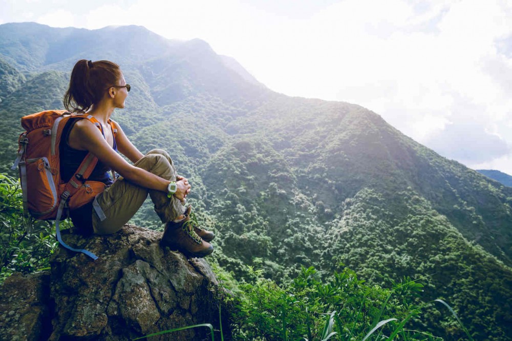 Woman hiker sit on mountain