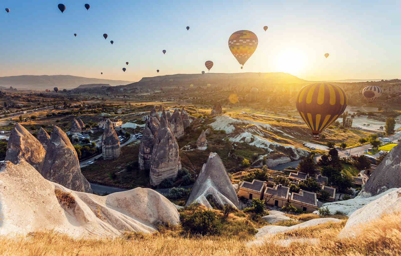 Uçan balonlarla dolu gökyüzü ve Kapadokya manzarası