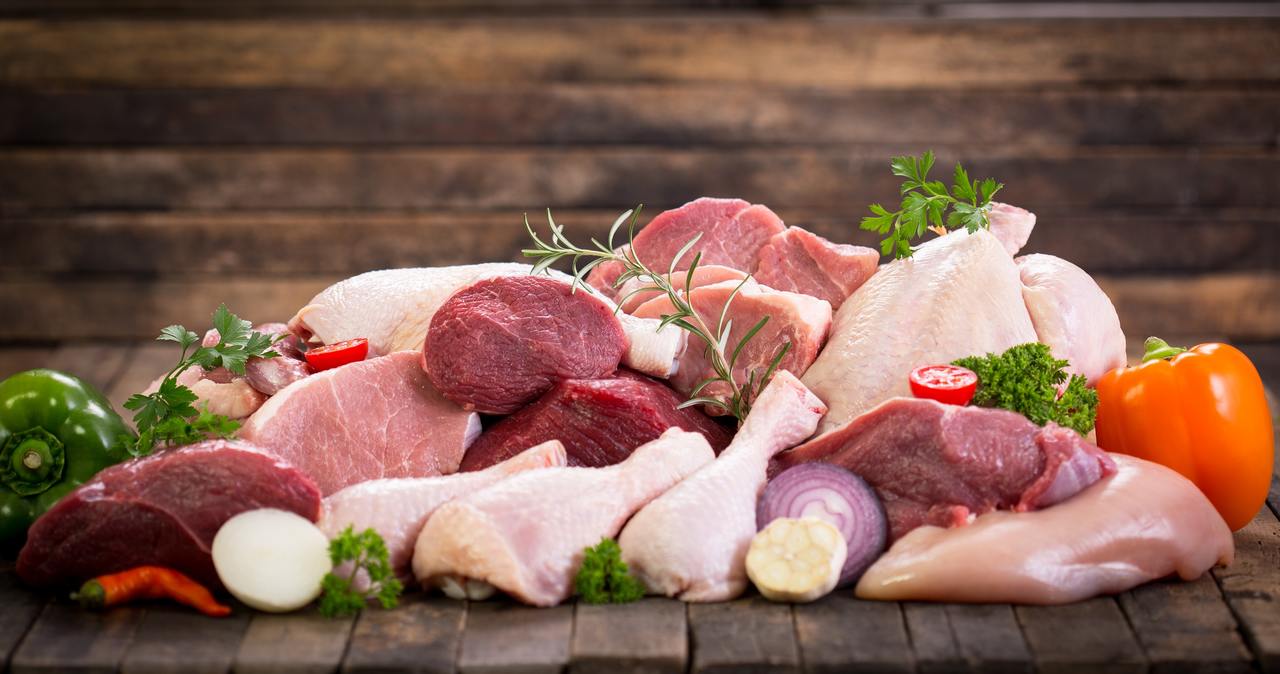 Ahşap masa üzerinde duran kırmızı et, beyaz et ve balık eti çeşitleri
