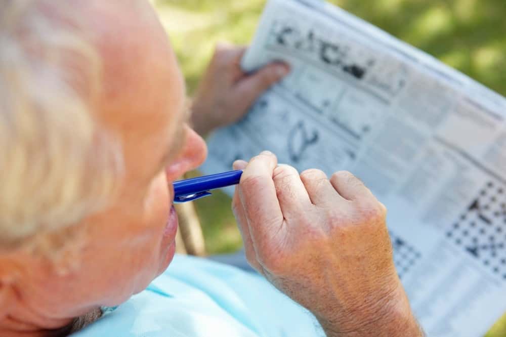 Unutkanlıkla mücadele etmek için gazetedeki bulmacaları çözmeye çalışan yaşlı adam