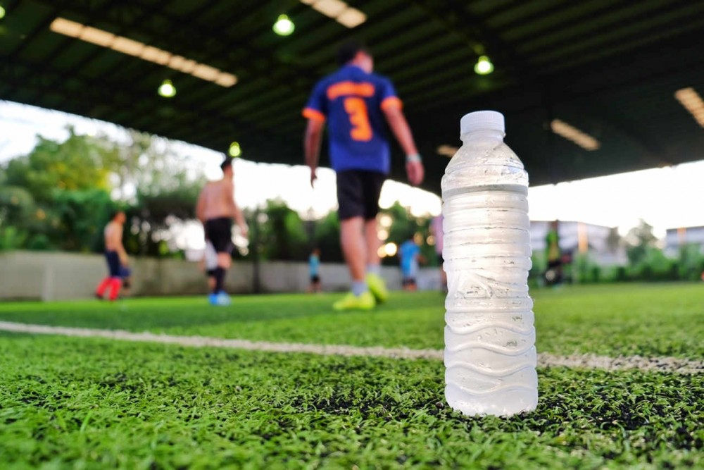 a bottle of water on the pitch for the soccer players to get hydrated
