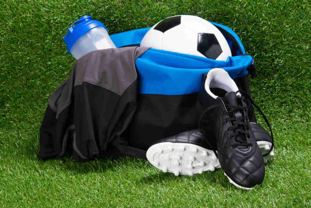 soccer equipments in the bag on the football pitch
