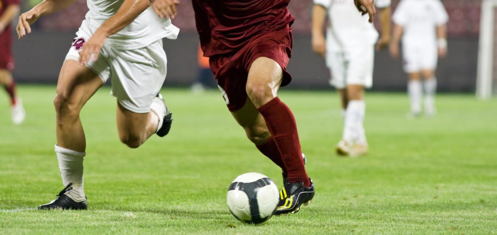 players play soccer within the professional match