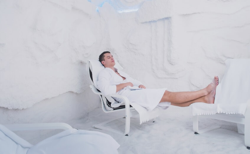 man relaxes in salt cave for asthma treatment
