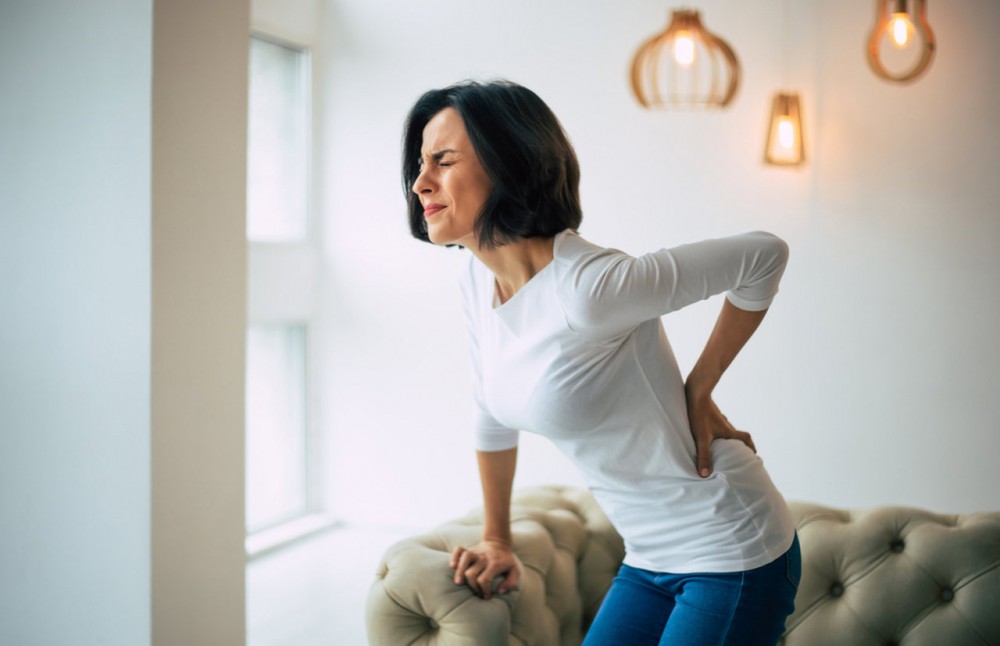 woman holding her back