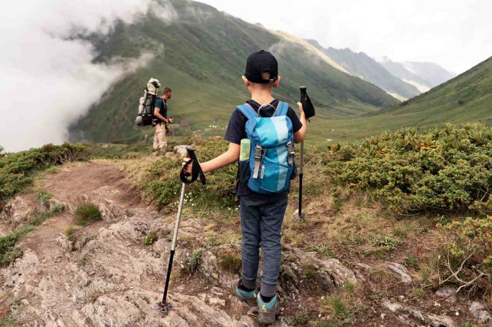 a man and child traveling together on the mountain