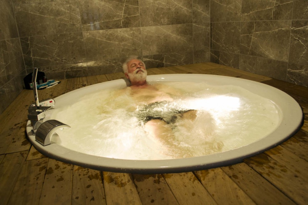 old man relaxing in the thermal water
