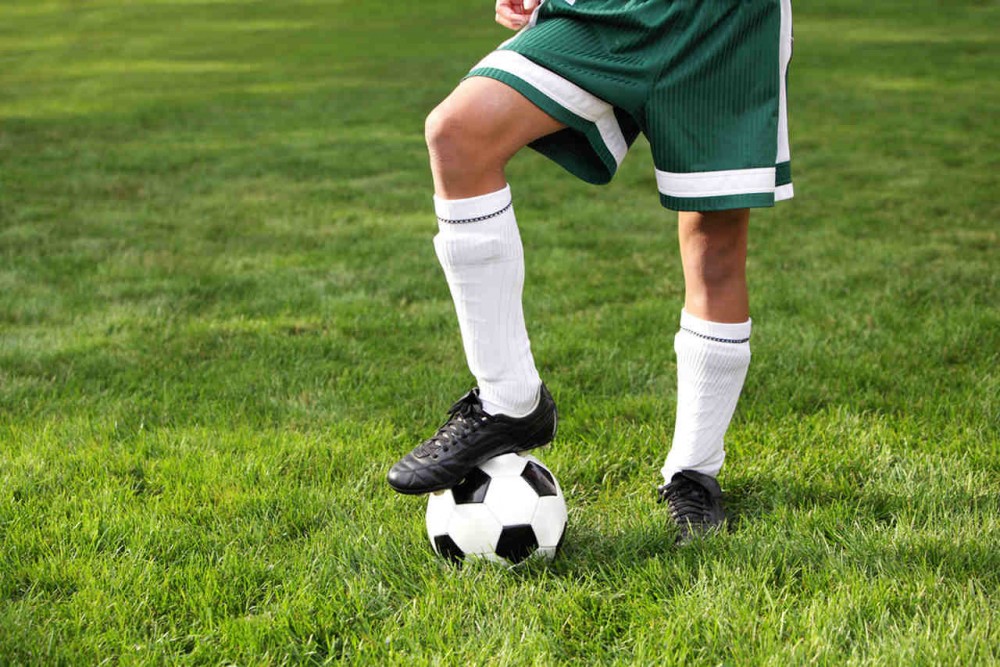 a soccer player with white soccer socks and shin guards inside the socks